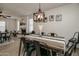 Modern farmhouse dining area with a view of the living room and fireplace at 6073 W Caribe Ln, Glendale, AZ 85306