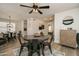 Charming dining area with a round table, four black chairs, and a stylish light fixture at 6073 W Caribe Ln, Glendale, AZ 85306