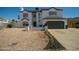 Two-story house with a gray-trimmed white exterior, a two-car garage, and a landscaped front yard at 6073 W Caribe Ln, Glendale, AZ 85306