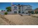 Two-story house with a gray-trimmed white exterior, a two-car garage, and a landscaped front yard at 6073 W Caribe Ln, Glendale, AZ 85306