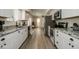 Long kitchen with granite countertops and white shaker cabinets at 6073 W Caribe Ln, Glendale, AZ 85306