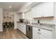 Bright kitchen featuring white shaker cabinets, granite counters, and stainless steel appliances at 6073 W Caribe Ln, Glendale, AZ 85306