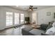 Living room with sectional sofa, pool view, and ceiling fan at 6073 W Caribe Ln, Glendale, AZ 85306