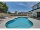 Inviting kidney-shaped pool with spacious patio and surrounding landscaping at 6073 W Caribe Ln, Glendale, AZ 85306