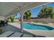 View of the refreshing pool from under the covered patio at 6073 W Caribe Ln, Glendale, AZ 85306