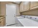 Laundry room with washer, dryer, and cabinets at 6970 E Hibiscus Way, Scottsdale, AZ 85266