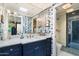 Stylish bathroom with blue vanity and walk-in shower at 7420 N San Manuel Rd, Scottsdale, AZ 85258