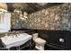 Powder room with pedestal sink and dark wallpaper at 7420 N San Manuel Rd, Scottsdale, AZ 85258