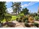 Landscaped yard with mature trees and desert plants at 7420 N San Manuel Rd, Scottsdale, AZ 85258