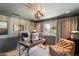 Home office with wood desk, leather chair, and large window at 7420 N San Manuel Rd, Scottsdale, AZ 85258