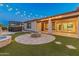 Outdoor entertaining area with fire pit and spa at 7556 W Crystal Rd, Glendale, AZ 85308