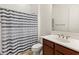 Bathroom with shower/tub, vanity, and striped curtain at 7556 W Crystal Rd, Glendale, AZ 85308