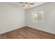 Bedroom with wood-look floors and ceiling fan at 7556 W Crystal Rd, Glendale, AZ 85308