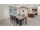 Bright dining room with table and chairs, view to kitchen and backyard at 7556 W Crystal Rd, Glendale, AZ 85308