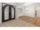 Elegant entryway with black double doors and tile flooring at 7556 W Crystal Rd, Glendale, AZ 85308