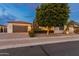 Single-story home with a two-car garage and lush landscaping at 7556 W Crystal Rd, Glendale, AZ 85308