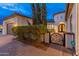 Neatly landscaped front yard with a gated entry and brick pavers at 7556 W Crystal Rd, Glendale, AZ 85308