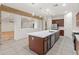 Modern kitchen with large island and stainless steel appliances at 7556 W Crystal Rd, Glendale, AZ 85308