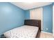 Small bedroom with a double bed and blue walls at 8055 S 7Th St, Phoenix, AZ 85042