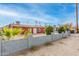 Red house with gray block wall and mature plants at 8055 S 7Th St, Phoenix, AZ 85042