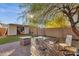 Landscaped backyard with brick patio, fire pit, shed, and lush greenery, great for outdoor enjoyment at 8219 W Globe Ave, Phoenix, AZ 85043