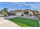 Charming single-story home with desert landscaping, artificial turf and a welcoming covered entrance at 8219 W Globe Ave, Phoenix, AZ 85043