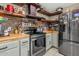 Modern kitchen featuring stainless steel appliances, floating shelves, and stylish countertops at 8219 W Globe Ave, Phoenix, AZ 85043