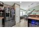 Modern kitchen with stainless steel refrigerator and an open layout to the adjacent dining area at 8219 W Globe Ave, Phoenix, AZ 85043