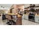 Stylish kitchen with a breakfast bar, stainless steel appliances, and a sliding barn door at 8219 W Globe Ave, Phoenix, AZ 85043