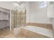 Spa-like bathroom with a soaking tub and a glass-enclosed shower at 8270 N Hayden Rd # 1023, Scottsdale, AZ 85258