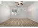 Well-lit bedroom with wood-look floors and plantation shutters at 8270 N Hayden Rd # 1023, Scottsdale, AZ 85258