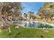 Peaceful community pond with a fountain and trees at 8270 N Hayden Rd # 1023, Scottsdale, AZ 85258