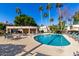 Community pool with lounge chairs and covered seating area at 8270 N Hayden Rd # 1023, Scottsdale, AZ 85258