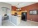 Kitchen with wood cabinets, black appliances, and a breakfast bar at 11029 W Mountain View Dr, Avondale, AZ 85323