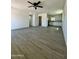 Spacious living room with new flooring and ceiling fan at 11713 W River Rd, El Mirage, AZ 85335