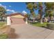 Front view of a house with a large driveway and American flag at 12506 W Castle Rock Dr, Sun City West, AZ 85375