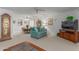 Bright living room featuring teal couches and a grandfather clock at 12506 W Castle Rock Dr, Sun City West, AZ 85375