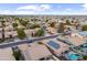 Aerial view showing neighborhood homes, some with solar panels and pools at 12522 W Llano Dr, Litchfield Park, AZ 85340