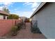 Private backyard with gated access, gravel landscaping, and mature plants at 12522 W Llano Dr, Litchfield Park, AZ 85340