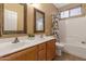 Clean bathroom with double sinks, a bathtub, and updated fixtures at 12522 W Llano Dr, Litchfield Park, AZ 85340