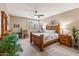 Main bedroom with wood furnishings and ceiling fan at 12522 W Llano Dr, Litchfield Park, AZ 85340