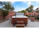 Relaxing hot tub with wooden steps and surrounding landscaping at 12522 W Llano Dr, Litchfield Park, AZ 85340