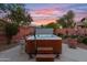 Relax in this luxurious hot tub, complete with steps and landscaping at 12522 W Llano Dr, Litchfield Park, AZ 85340