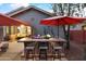 Outdoor kitchen with bar seating, grill, and a large shade umbrella at 12522 W Llano Dr, Litchfield Park, AZ 85340