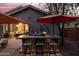 Stunning outdoor kitchen with bar seating under a patio umbrella at 12522 W Llano Dr, Litchfield Park, AZ 85340