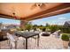 Outdoor patio with dining table, fire pit, and comfortable seating at 12911 W Eagle Ridge Ln, Peoria, AZ 85383