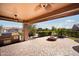 Covered patio with built-in grill, fire pit, and seating area at 12911 W Eagle Ridge Ln, Peoria, AZ 85383