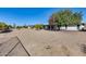 Large backyard landscaped with gravel, mature trees, and a partial view of the home's exterior at 13219 W Prospect Dr, Sun City West, AZ 85375