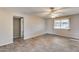 Sunny bedroom features tile flooring, a ceiling fan, and a large window providing natural light at 13219 W Prospect Dr, Sun City West, AZ 85375