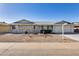 A charming single-story home features a spacious driveway and low maintenance desert landscaping at 13219 W Prospect Dr, Sun City West, AZ 85375